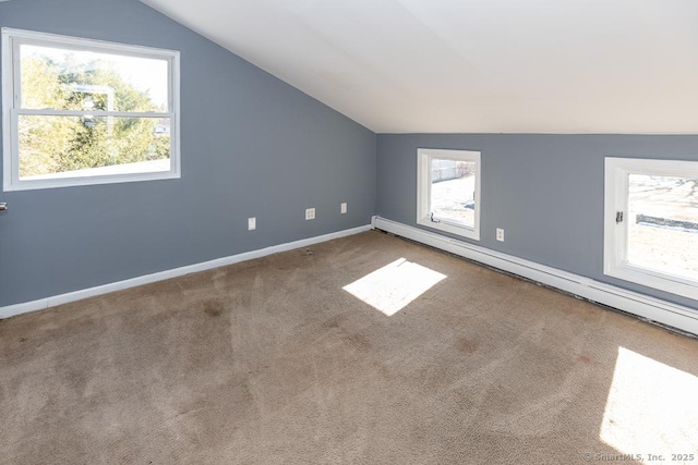 additional living space featuring a baseboard radiator, lofted ceiling, and carpet