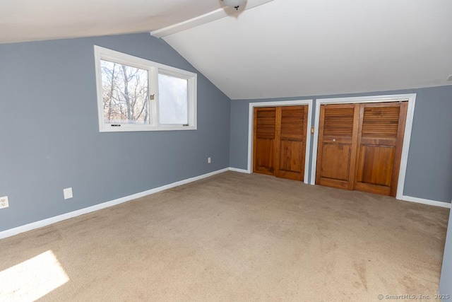 bonus room featuring lofted ceiling and carpet flooring