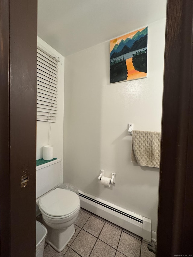 bathroom with tile patterned floors, toilet, and baseboard heating