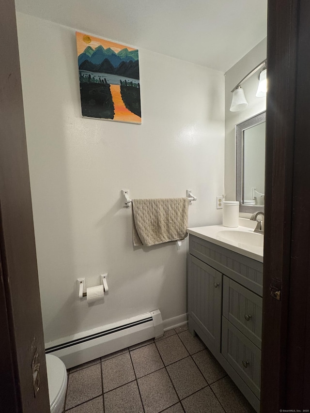 bathroom with baseboard heating, tile patterned floors, vanity, and toilet