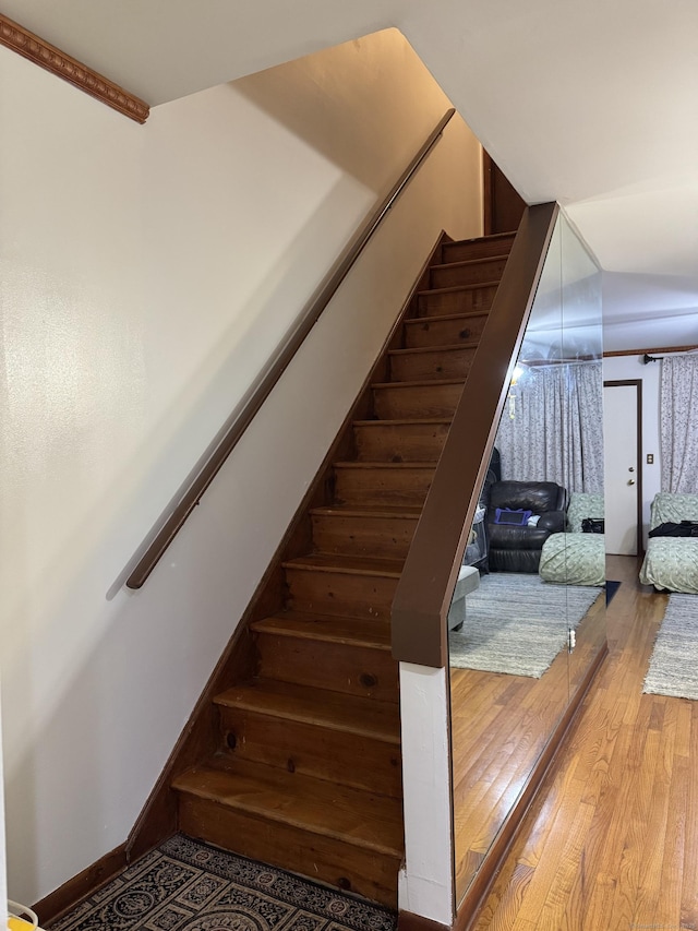 stairs featuring hardwood / wood-style flooring