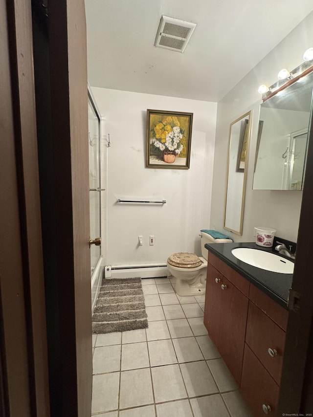 full bathroom featuring combined bath / shower with glass door, tile patterned flooring, vanity, a baseboard heating unit, and toilet