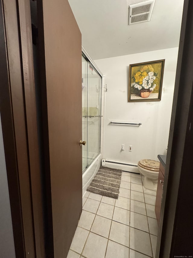 full bathroom with tile patterned floors, toilet, vanity, enclosed tub / shower combo, and a baseboard heating unit