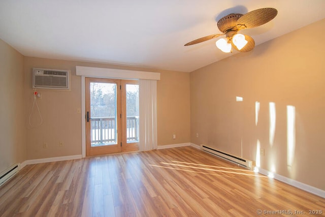 spare room featuring a wall mounted air conditioner, light hardwood / wood-style flooring, ceiling fan, and baseboard heating