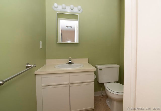 bathroom with vanity, tile patterned flooring, and toilet