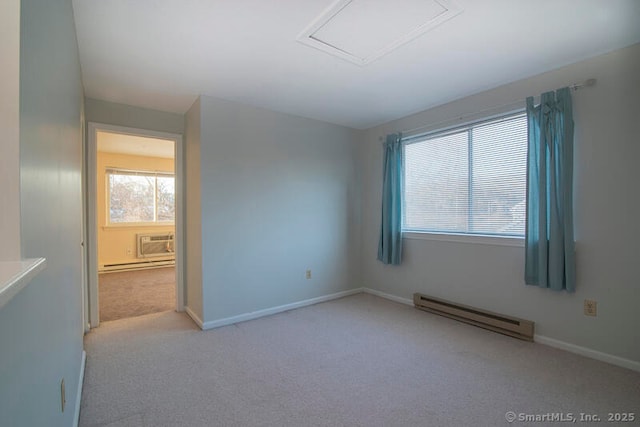 empty room with a baseboard radiator, a healthy amount of sunlight, and light carpet