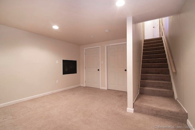 basement featuring light carpet