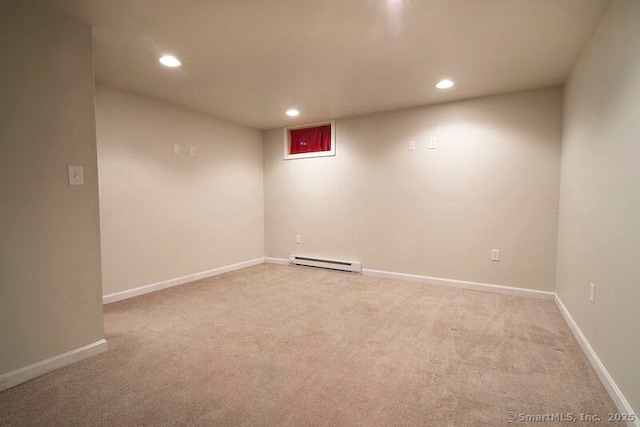 carpeted spare room with baseboard heating