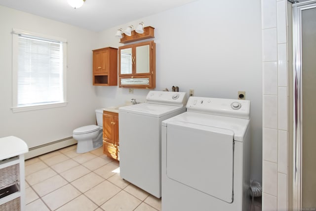 clothes washing area with light tile patterned floors, a baseboard radiator, and washing machine and dryer