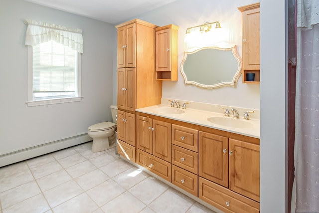 bathroom featuring vanity, tile patterned floors, baseboard heating, and toilet