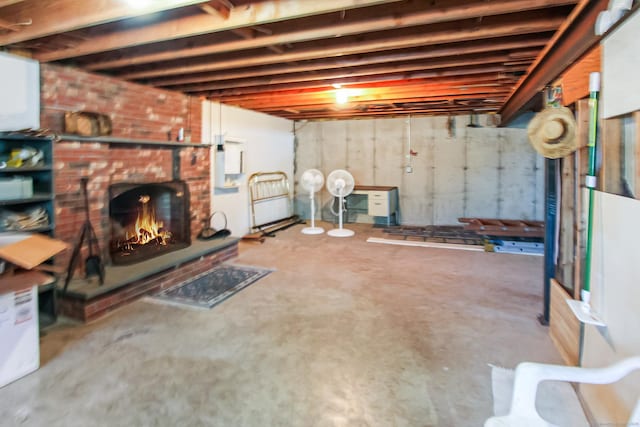 basement featuring a brick fireplace