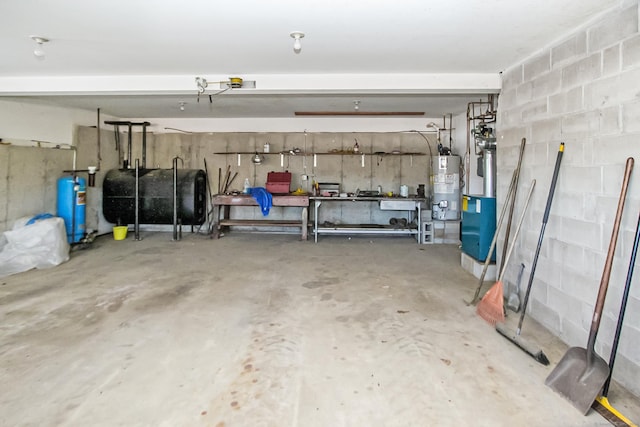 garage featuring gas water heater and a workshop area