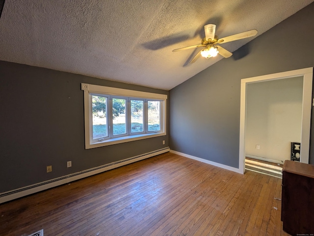 unfurnished room with wood-type flooring, vaulted ceiling, a textured ceiling, ceiling fan, and a baseboard heating unit