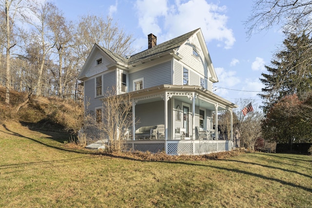 view of home's exterior featuring a yard and a porch