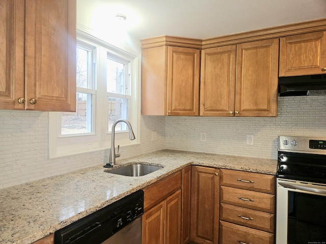 kitchen with stainless steel appliances, tasteful backsplash, light stone countertops, and sink