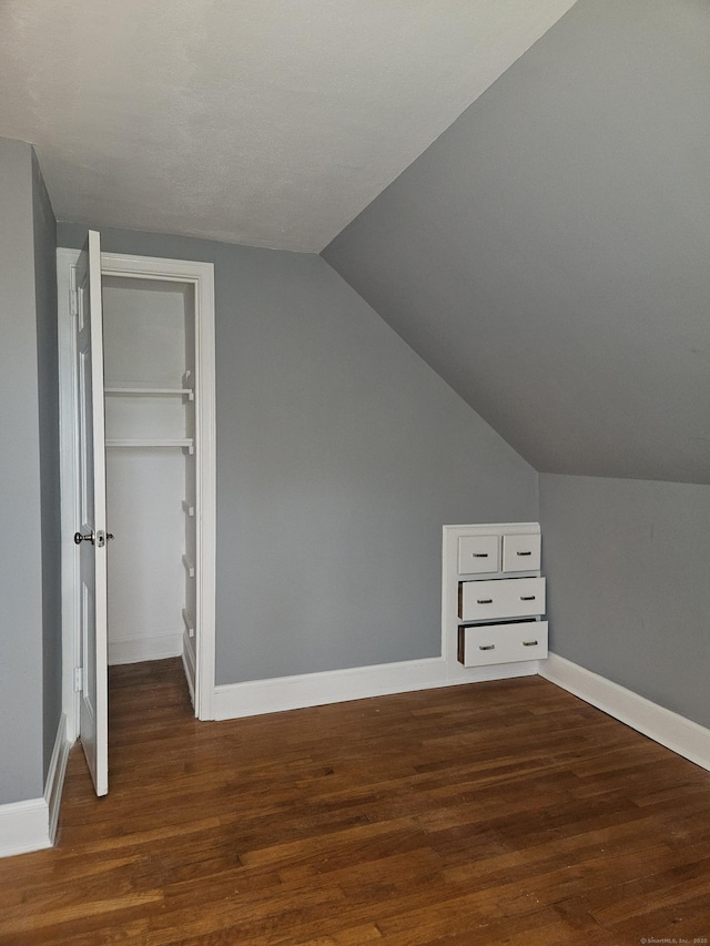 bonus room featuring lofted ceiling and dark wood-type flooring