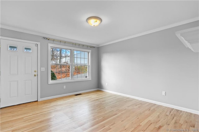 entrance foyer with crown molding and light wood-type flooring