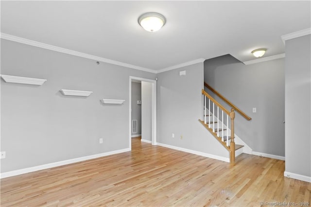 spare room with crown molding and light hardwood / wood-style floors