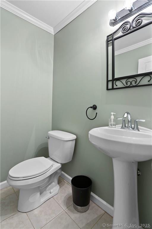 bathroom with ornamental molding, tile patterned floors, and toilet