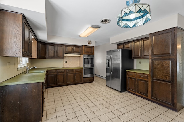 kitchen with tasteful backsplash, stainless steel appliances, sink, and dark brown cabinets