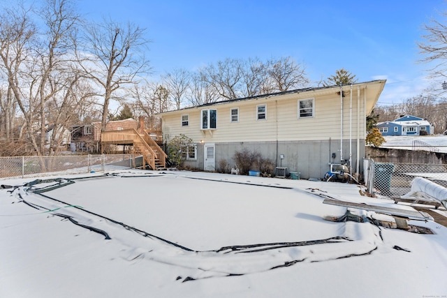 view of snow covered rear of property