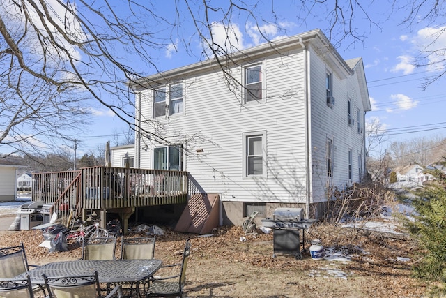 back of property with a wooden deck