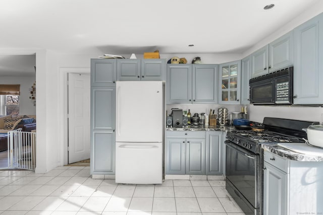 kitchen with gray cabinets, light tile patterned floors, and black appliances