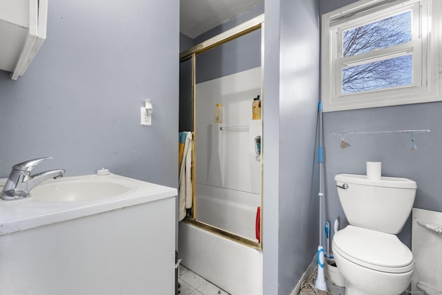 full bathroom featuring toilet, vanity, and shower / bath combination with glass door