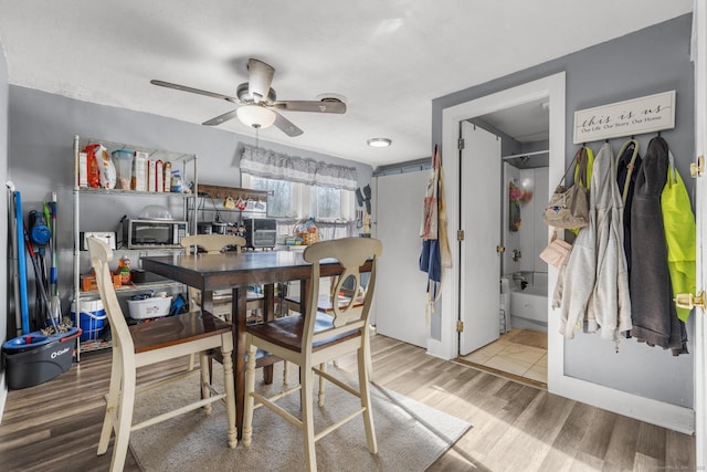 dining room with hardwood / wood-style flooring and ceiling fan