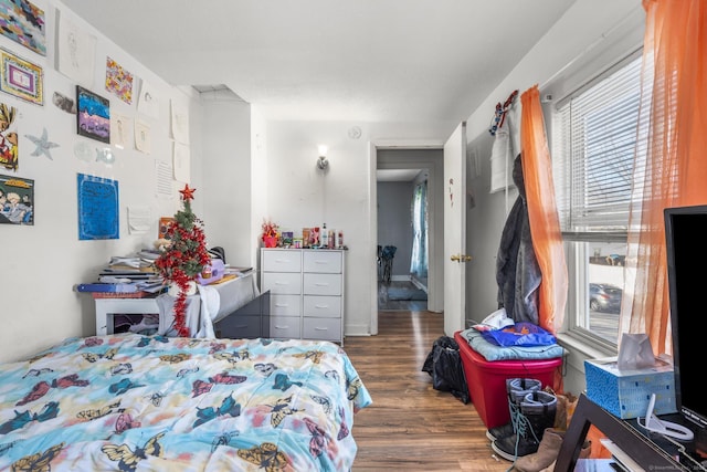 bedroom with dark wood-type flooring