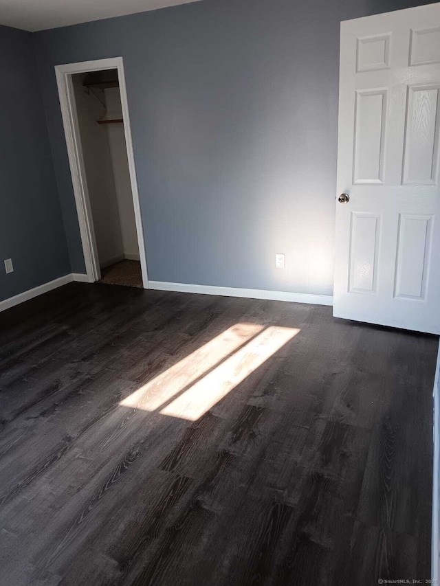 spare room featuring dark wood-type flooring