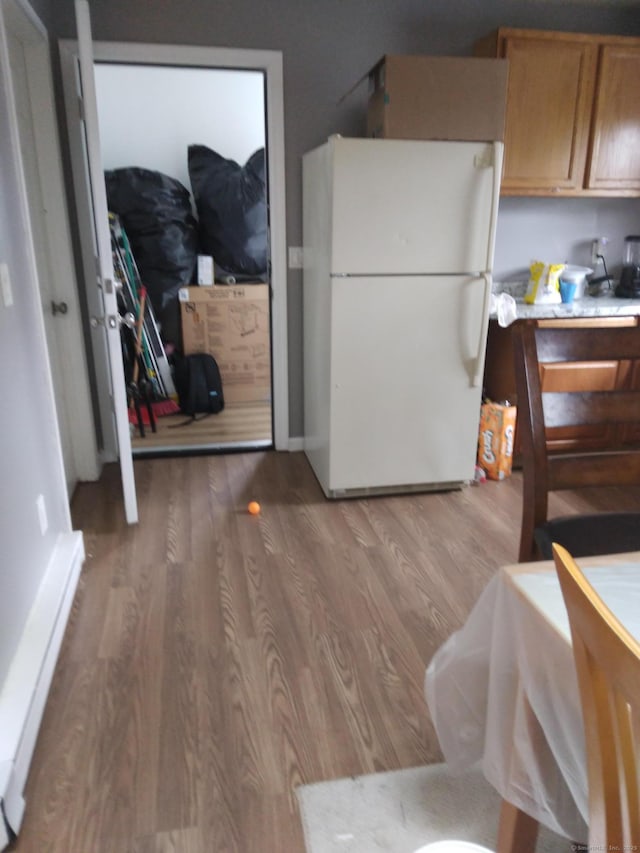 kitchen featuring light hardwood / wood-style flooring and white refrigerator