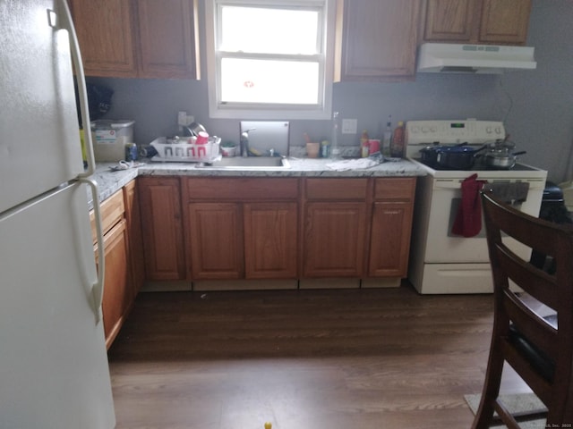 kitchen with sink, white appliances, and dark hardwood / wood-style floors