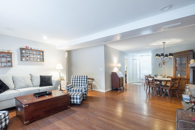 living room featuring an inviting chandelier and dark hardwood / wood-style flooring