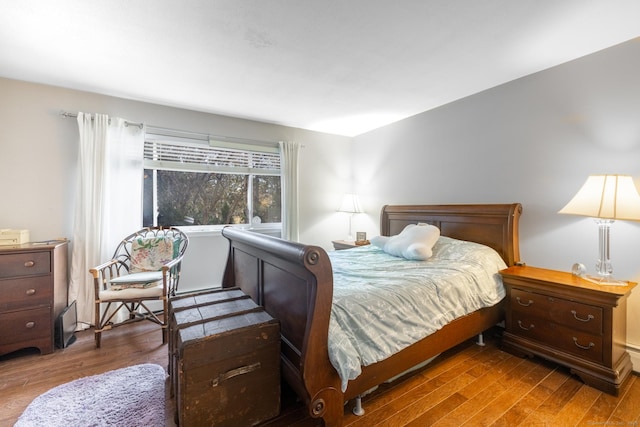 bedroom with dark wood-type flooring