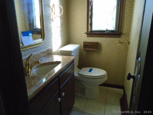 bathroom with tile patterned floors, toilet, and vanity