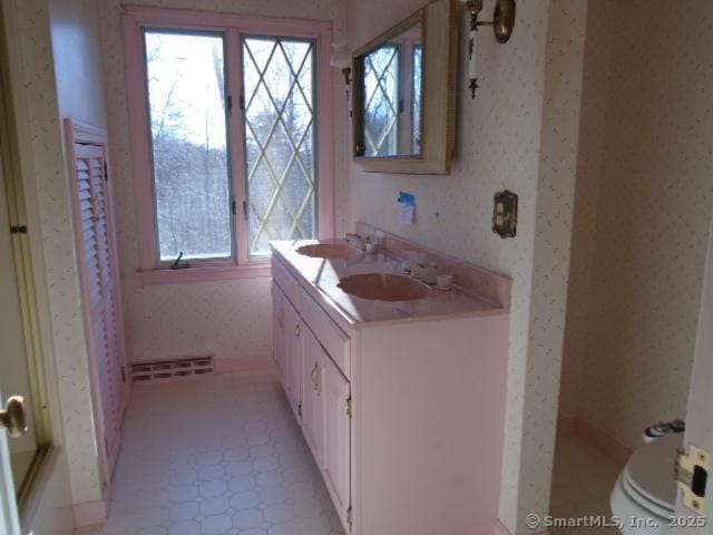 bathroom featuring vanity and toilet