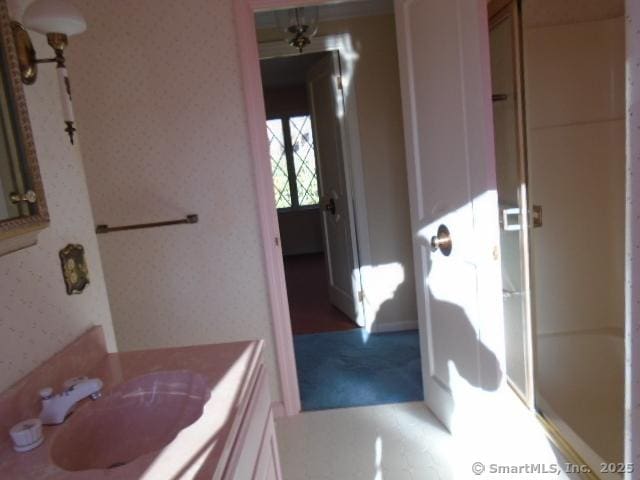 bathroom featuring vanity and bath / shower combo with glass door