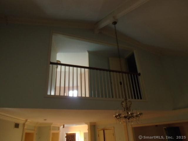 room details with beamed ceiling and an inviting chandelier