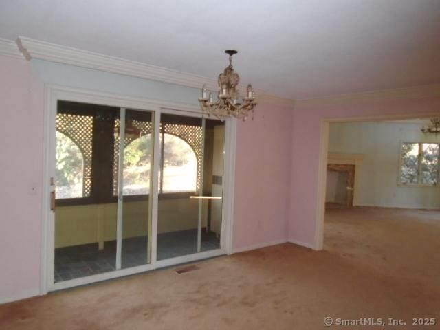 interior space featuring a notable chandelier, crown molding, and a wealth of natural light