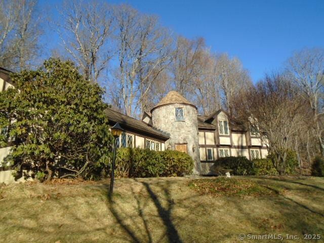 rear view of property with a yard