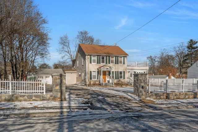 colonial inspired home with a shed