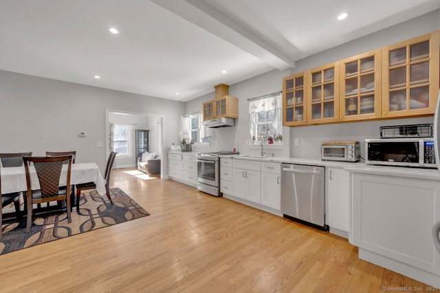 kitchen with sink, stainless steel appliances, light hardwood / wood-style floors, and white cabinets