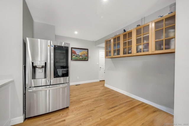 kitchen featuring light hardwood / wood-style floors and stainless steel fridge with ice dispenser