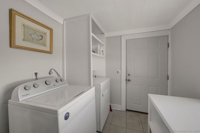 washroom featuring separate washer and dryer, light tile patterned floors, and ornamental molding