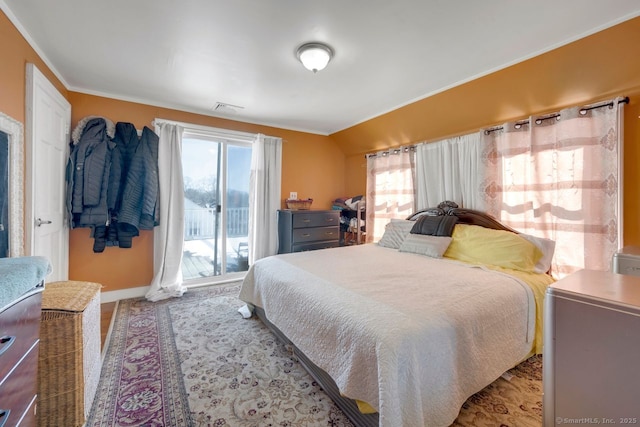 bedroom with lofted ceiling and access to exterior