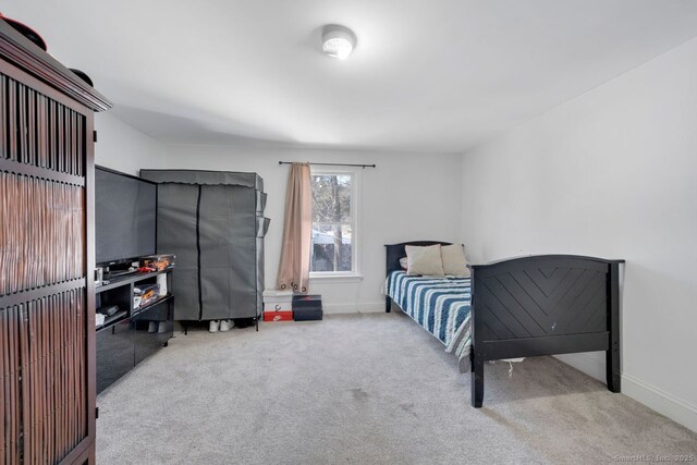 bedroom featuring light colored carpet