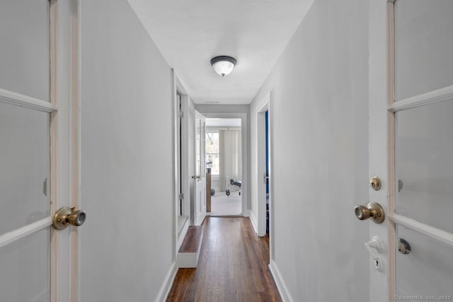 hallway with dark wood-type flooring