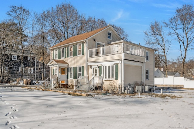 view of front of house featuring cooling unit and a balcony