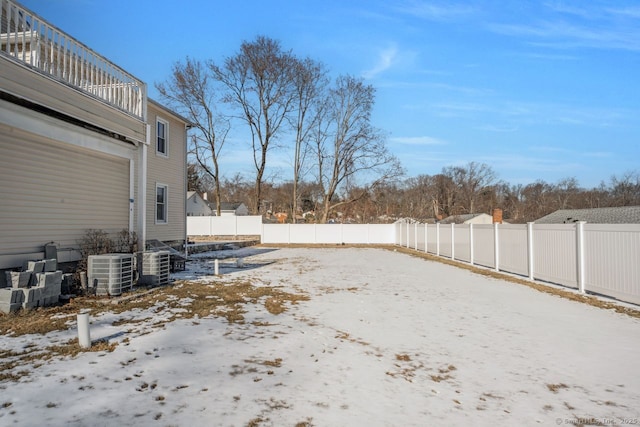 yard layered in snow with cooling unit